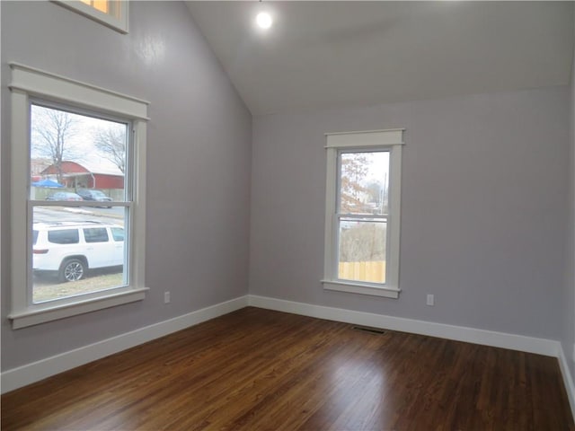 additional living space featuring lofted ceiling and dark hardwood / wood-style flooring