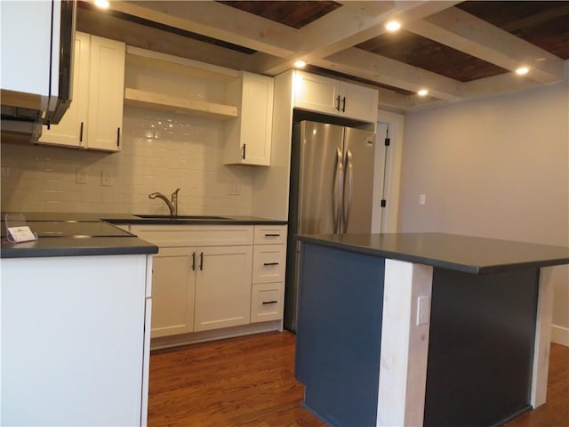 kitchen with stainless steel fridge, a center island, sink, and white cabinets