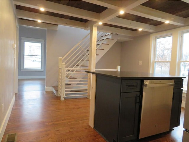 kitchen featuring beamed ceiling, dishwasher, a kitchen island, and dark hardwood / wood-style flooring