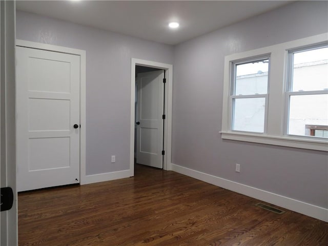 unfurnished bedroom featuring dark hardwood / wood-style flooring