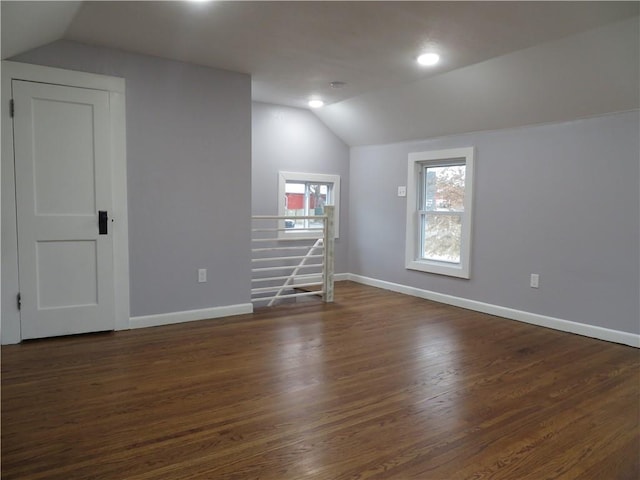 interior space with lofted ceiling and dark wood-type flooring