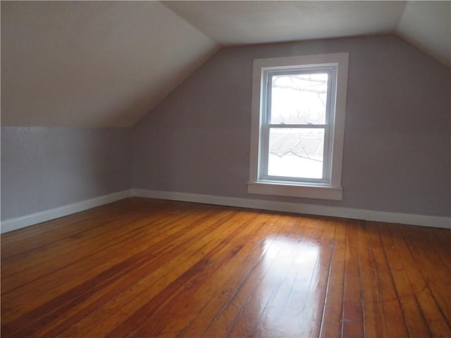 bonus room with vaulted ceiling and hardwood / wood-style floors