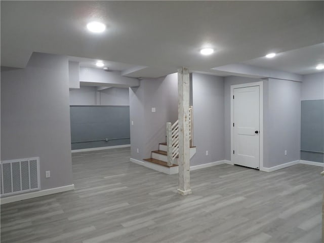 basement with light hardwood / wood-style floors