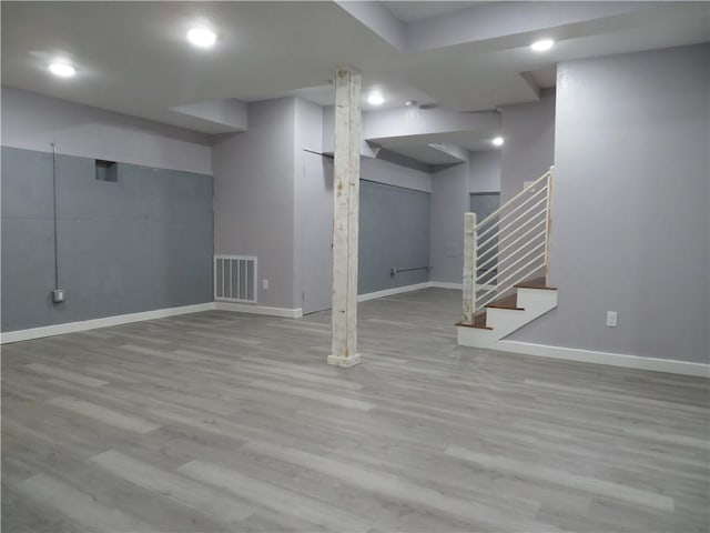 basement with light hardwood / wood-style floors