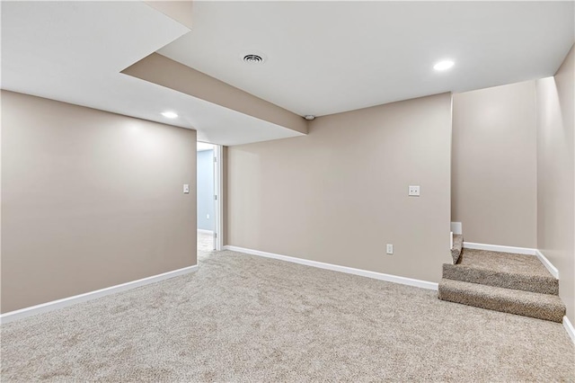 finished basement with recessed lighting, visible vents, stairway, carpet flooring, and baseboards