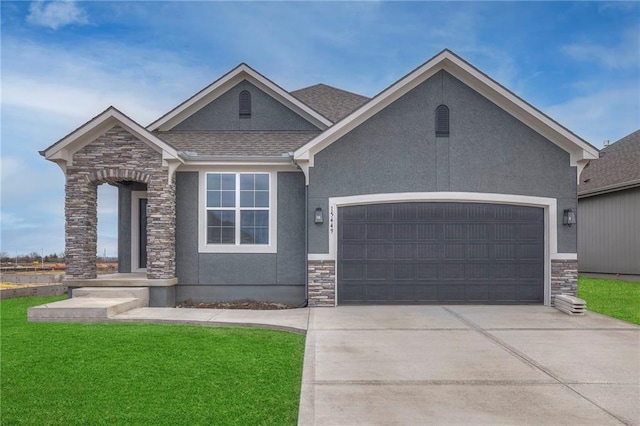 view of front of house with a garage and a front lawn