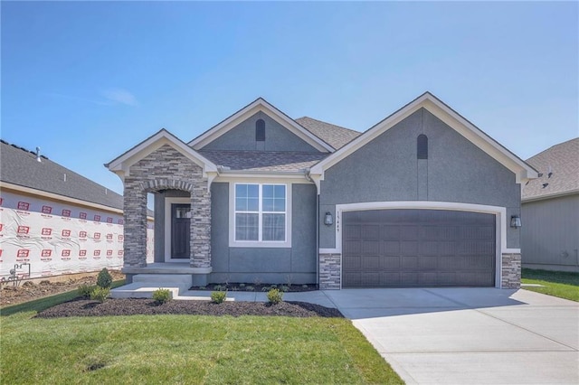 view of front of property featuring a garage and a front lawn