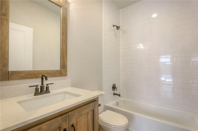 full bathroom featuring tiled shower / bath, vanity, and toilet