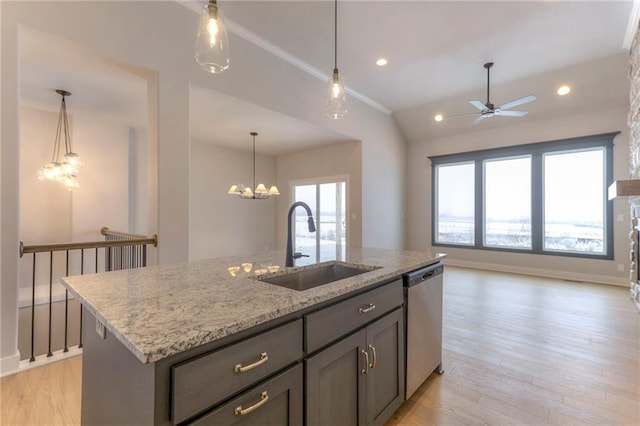 kitchen with sink, stainless steel dishwasher, an island with sink, light stone countertops, and light hardwood / wood-style floors