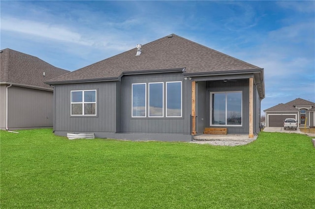 back of house featuring a garage and a yard