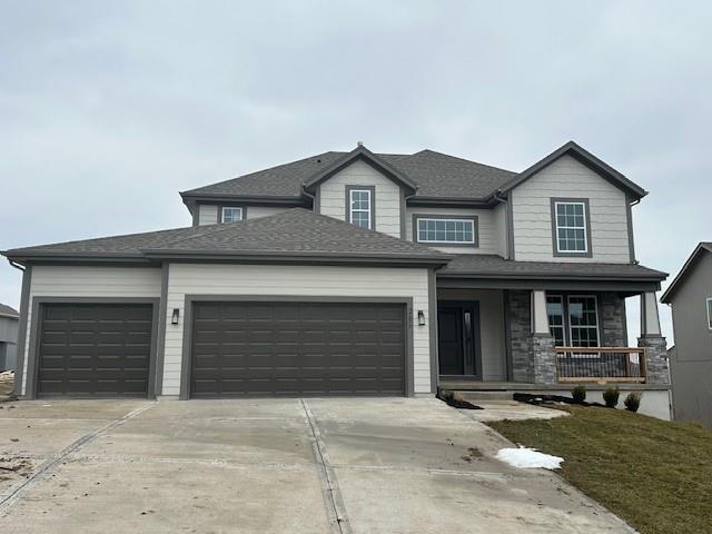 view of front of property featuring a porch and a garage