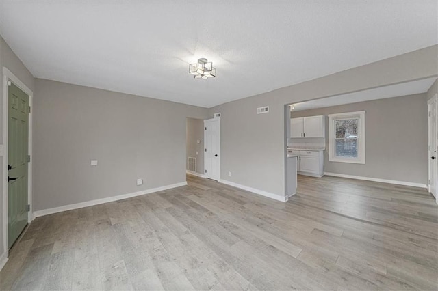 unfurnished living room featuring light wood-type flooring