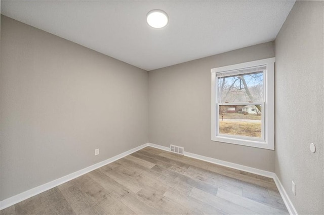 spare room featuring light hardwood / wood-style flooring