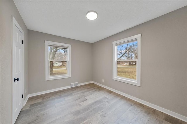 spare room with light wood-type flooring