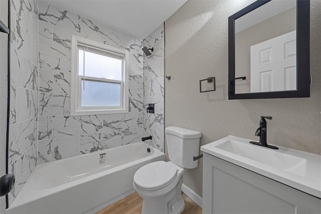 full bathroom featuring vanity, tiled shower / bath combo, wood-type flooring, and toilet