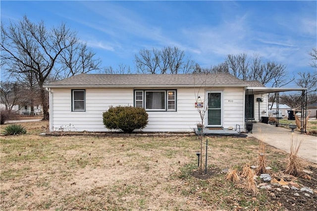 ranch-style home with a carport and a front yard