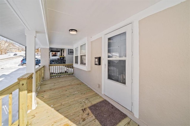 wooden terrace featuring covered porch