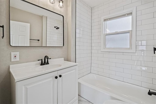 bathroom featuring vanity and tiled shower / bath