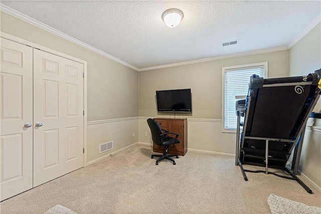 office area with a textured ceiling, visible vents, and light colored carpet