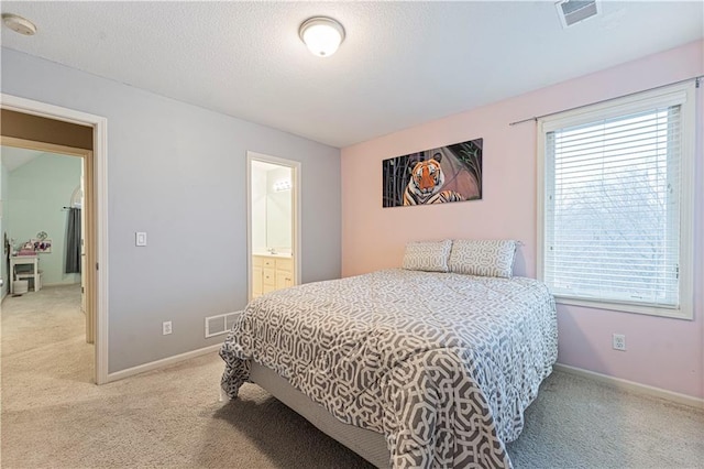 bedroom featuring light colored carpet, visible vents, and baseboards