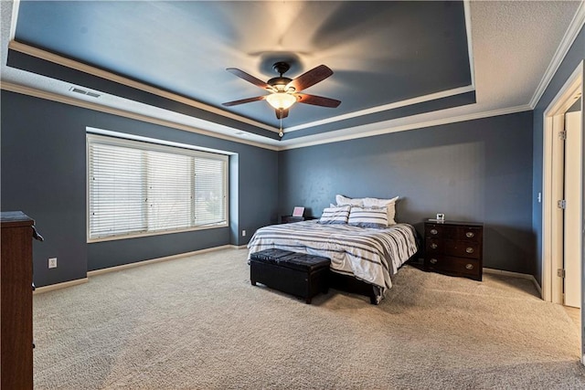 bedroom featuring light colored carpet, visible vents, baseboards, ornamental molding, and a raised ceiling