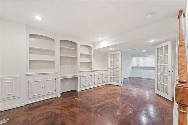 unfurnished living room with french doors, recessed lighting, and built in features