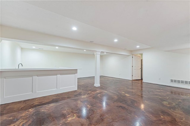 finished basement featuring baseboards, visible vents, and recessed lighting