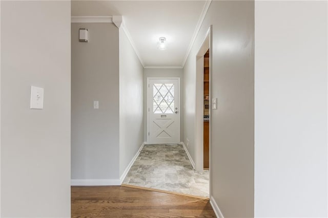 entryway with hardwood / wood-style flooring and ornamental molding