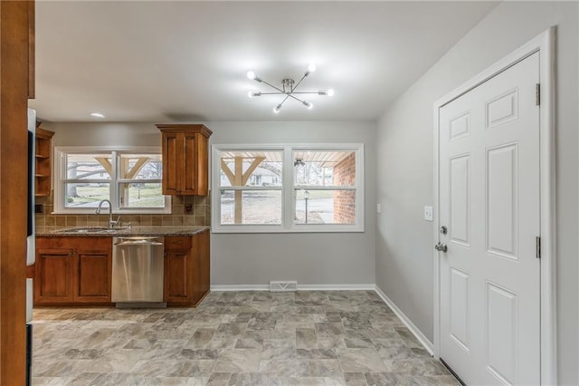 kitchen featuring sink, decorative backsplash, dishwasher, and stone counters