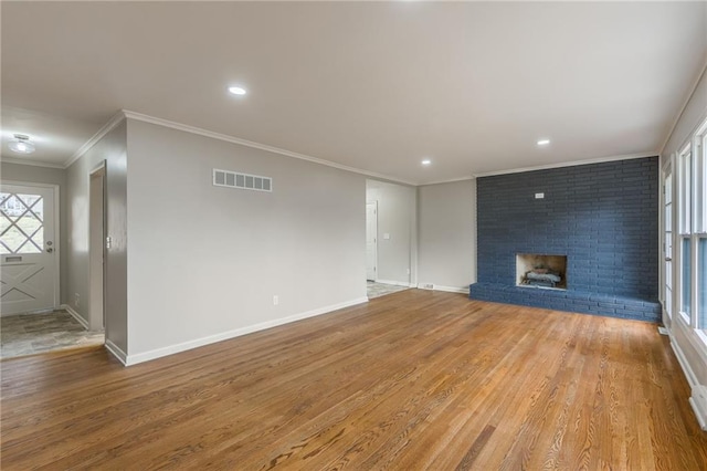 unfurnished living room featuring crown molding, a fireplace, and light hardwood / wood-style flooring