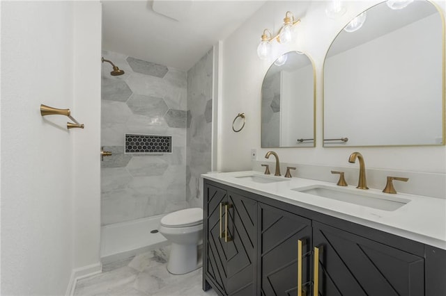 full bath featuring marble finish floor, a sink, toilet, and double vanity