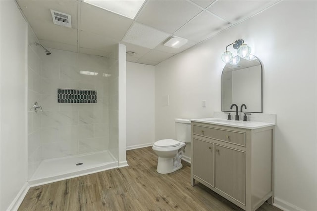 full bathroom with visible vents, toilet, a stall shower, vanity, and wood finished floors