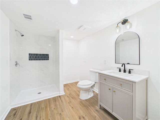 3201 S Norton Ave, Independence, MO 64052 - full bath featuring toilet, wood finished floors, vanity, baseboards, and visible vents