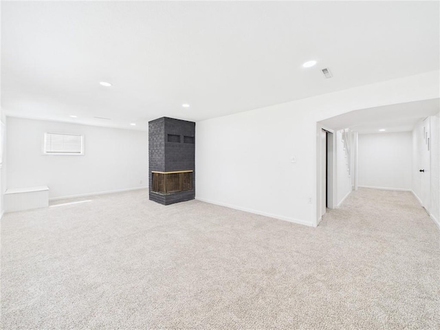 3201 S Norton Ave, Independence, MO 64052 - basement with a fireplace, light carpet, and recessed lighting