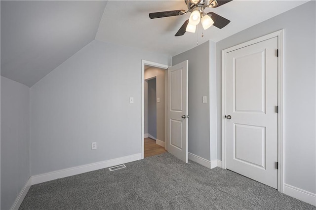 interior space featuring vaulted ceiling, carpet, and ceiling fan