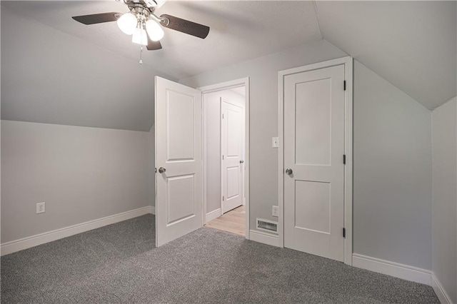 additional living space featuring lofted ceiling, light carpet, and ceiling fan