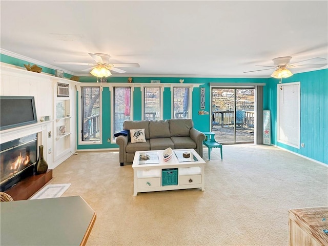 living room featuring crown molding, light colored carpet, and ceiling fan