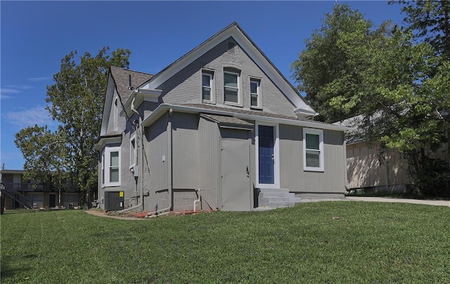 view of front of property featuring central AC and a front lawn