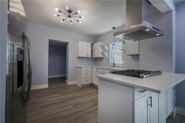 kitchen featuring white cabinetry, island range hood, stainless steel appliances, and hanging light fixtures