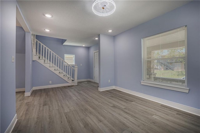 unfurnished living room with wood-type flooring