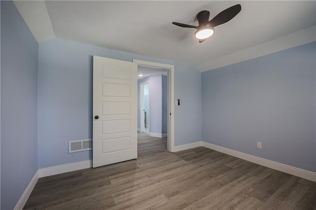 spare room with lofted ceiling, hardwood / wood-style flooring, and ceiling fan