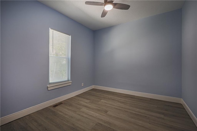 spare room featuring hardwood / wood-style flooring and ceiling fan