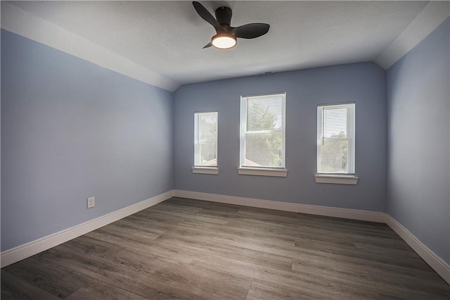 unfurnished room with ceiling fan, lofted ceiling, and hardwood / wood-style floors