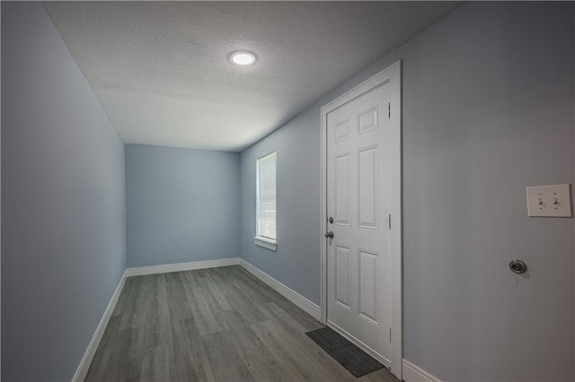 entryway featuring light hardwood / wood-style floors and a textured ceiling