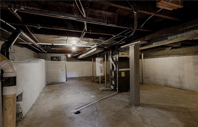 basement featuring water heater and heating unit