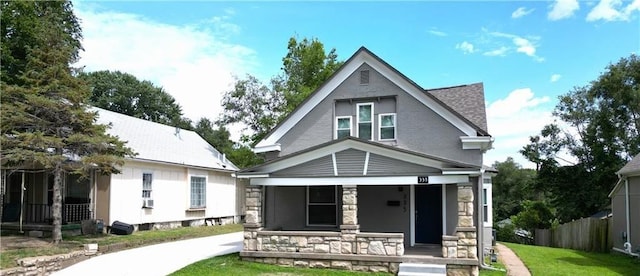 view of front of property with a porch and a front yard