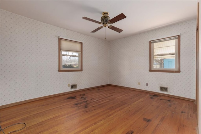 empty room with wood-type flooring and ceiling fan