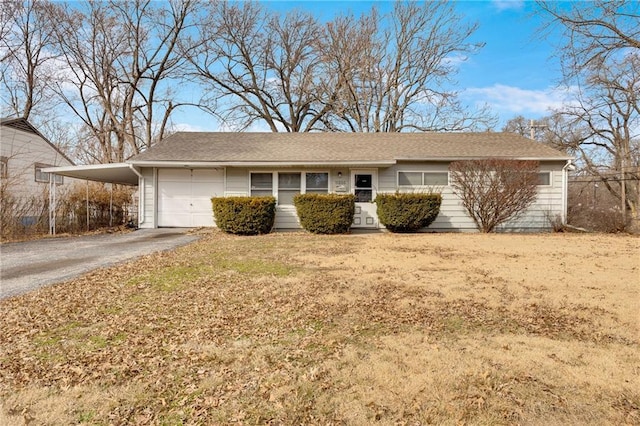 ranch-style home featuring a garage and a carport