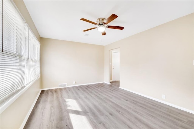 spare room with light hardwood / wood-style floors and ceiling fan