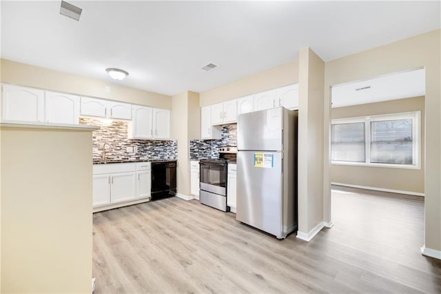 kitchen featuring sink, tasteful backsplash, appliances with stainless steel finishes, light hardwood / wood-style floors, and white cabinets